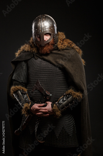 Warrior Viking in full arms with axe on dark background © Fotokvadrat