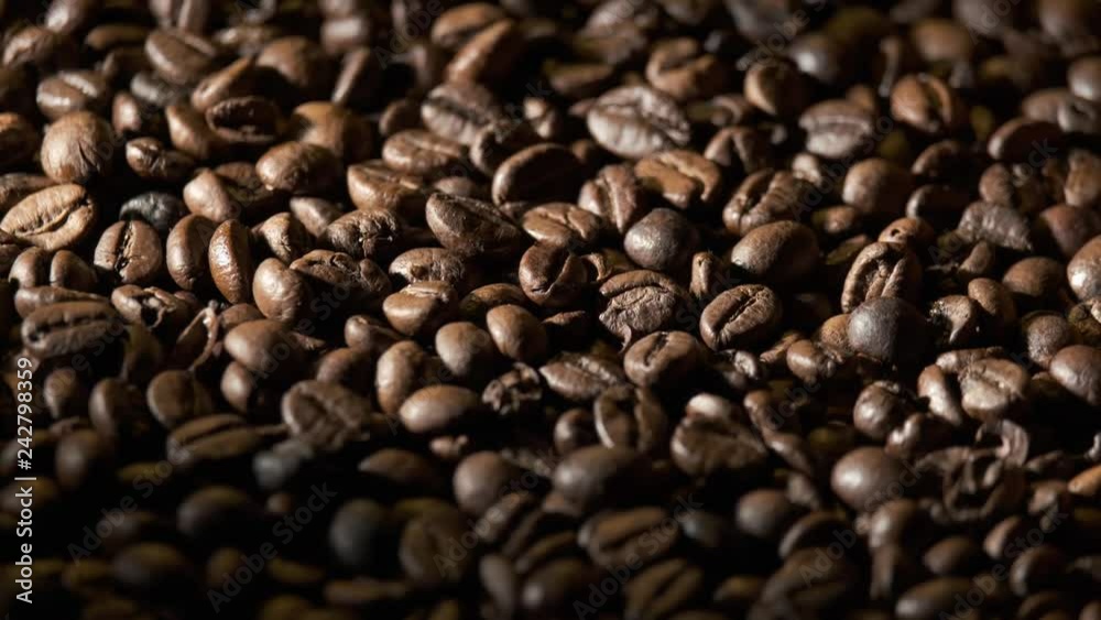 Many Roasted Coffee beans rotating. Slow motion. Many Roasted Coffee beans rotating. Slow motion.