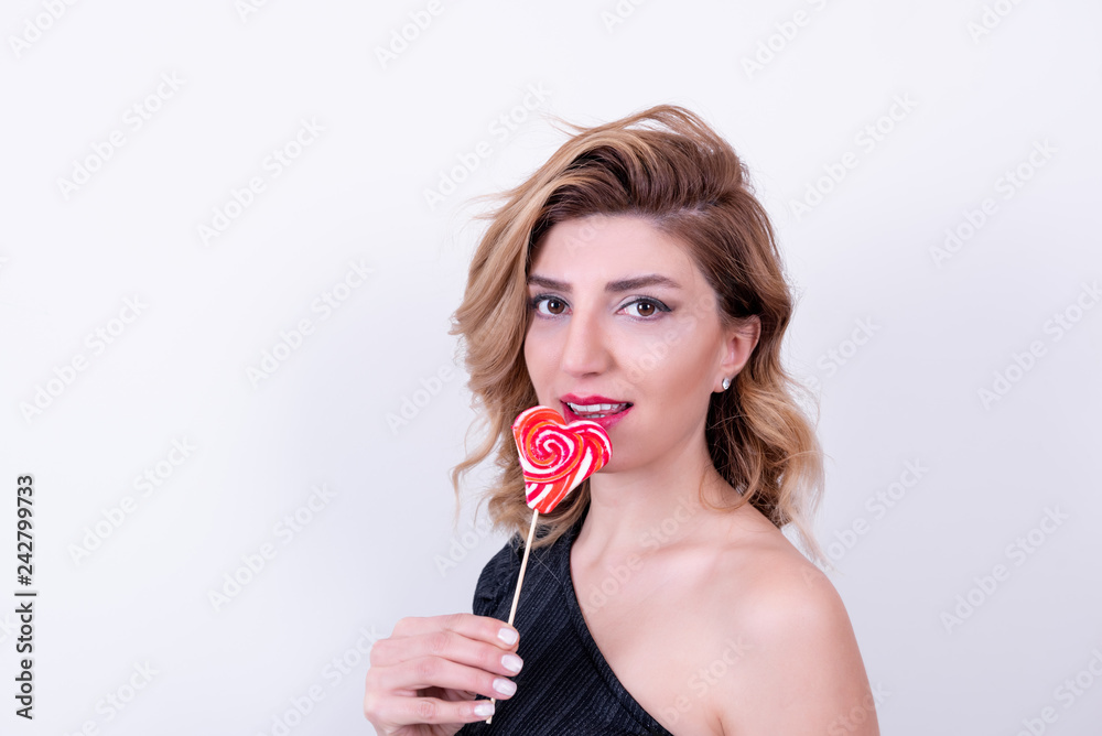 Beautiful model Girl with heart shaped lollipop Beautiful model Girl with heart shaped lollipop