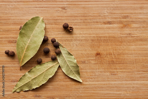 Spices on wood background. Pepper, Bay leaf, Basil