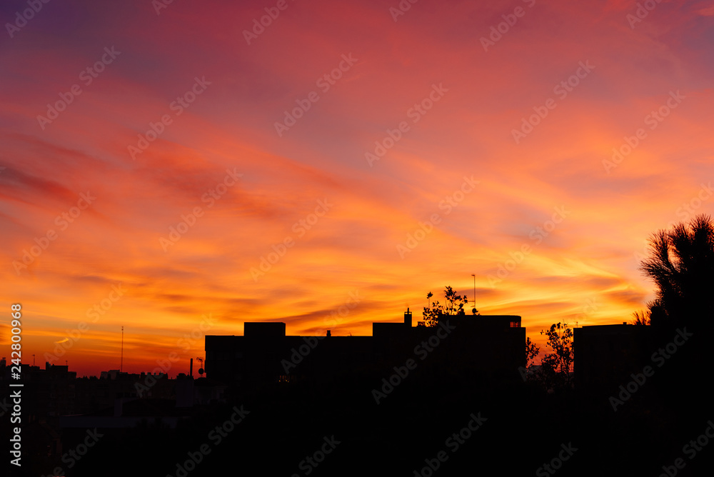 Beautiful orange sunset over Madrid and building silhouettes