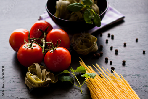 Italian pasta food on wooden background. Garlic, Tomatoes, Basil, Spicy