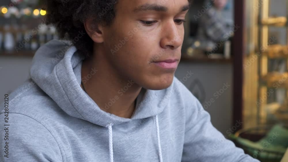 Man drinking coffee and using mobile phone in cafe Man drinking coffee and using mobile phone in cafe