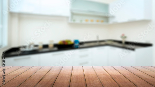 Wood table top with blur kitchen room background. Copy space for product display or design key visual layout