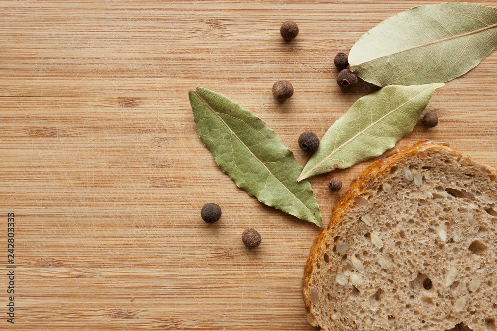 Herb leaves and bread on wooden background. Herb leaves and bread on wooden background.