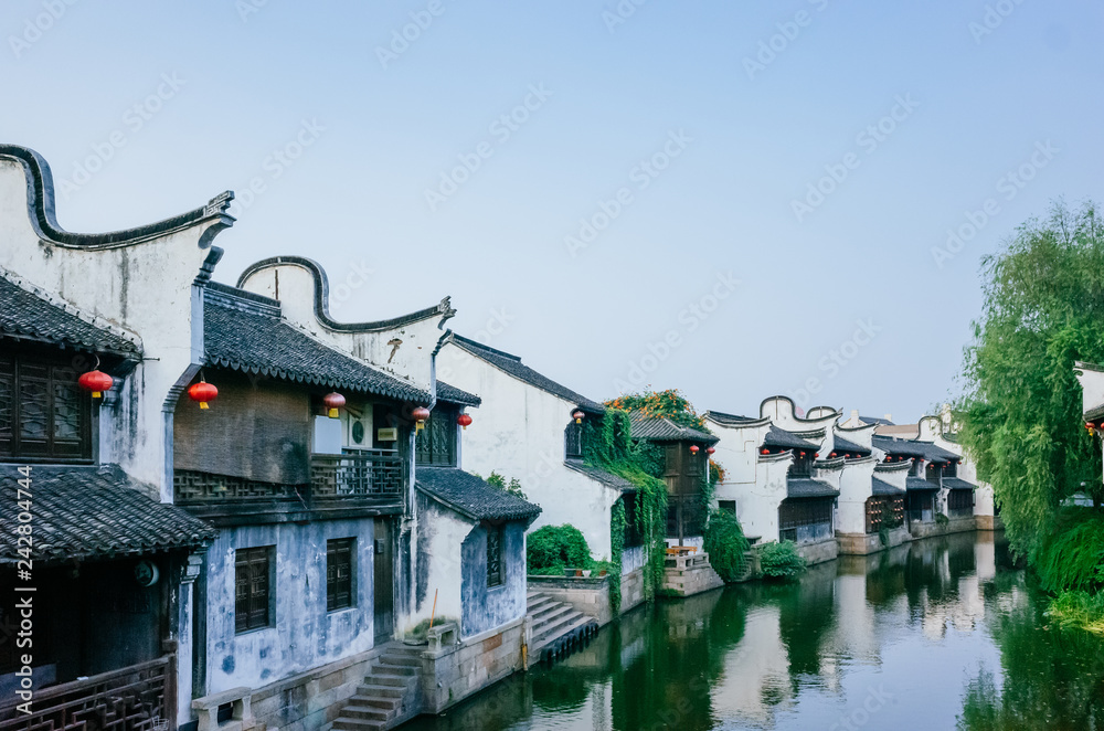 Traditional Chinese black and white houses by river, in downtown Jiaxing, China