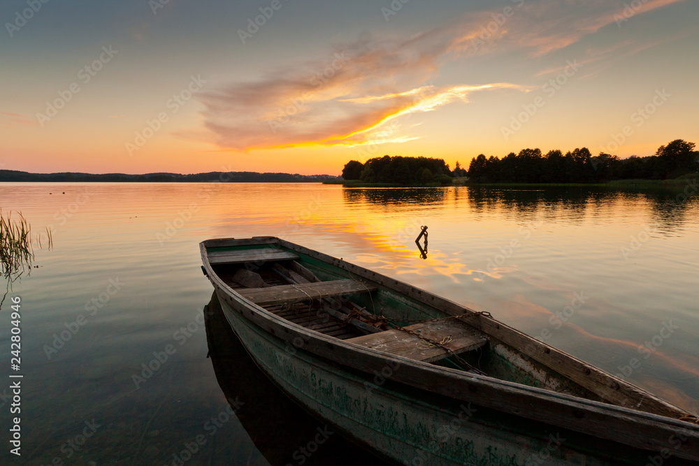 Lonely boat landscape with sunrise