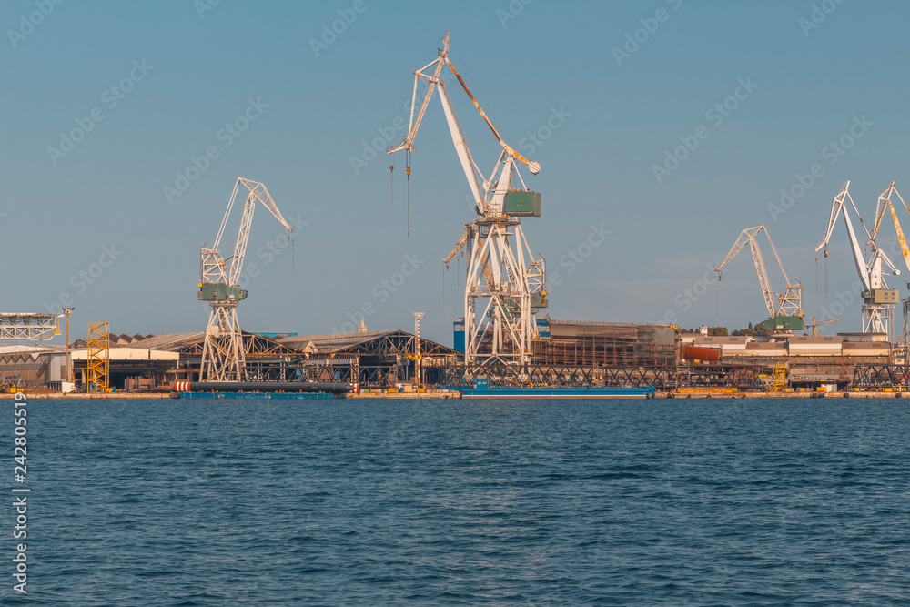Obraz premium dockyard in Pula with cranes while loading a ship, industry