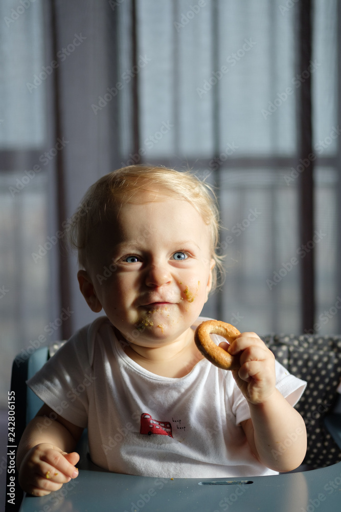 Feeding a baby in a highchair. Food Dirty Kid Feeding a baby in a highchair. Food Dirty Kid
