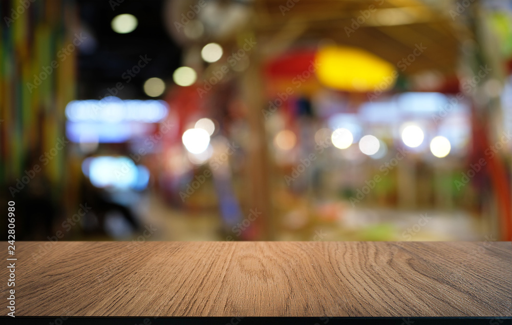 Empty dark wooden table in front of abstract blurred bokeh background of restaurant . can be used for display or montage your products.Mock up for space. Empty dark wooden table in front of abstract blurred bokeh background of restaurant . can be used for display or montage your products.Mock up for space.