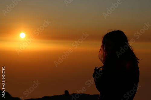 Lady looks over dharamshala india mountains sunset