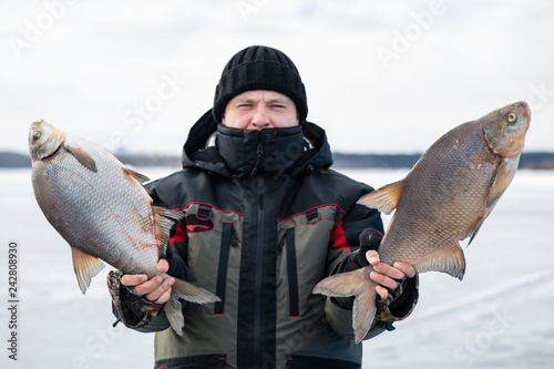 Winter fishing. The happy smiling angler with bream