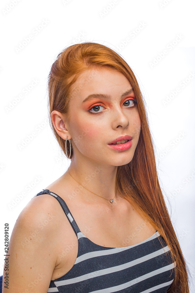 Portrait of a beautiful young girl with bright pink make-up and combed wet hair on an isolated background looking into the frame Portrait of a beautiful young girl with bright pink make-up and combed wet hair on an isolated background looking into the frame