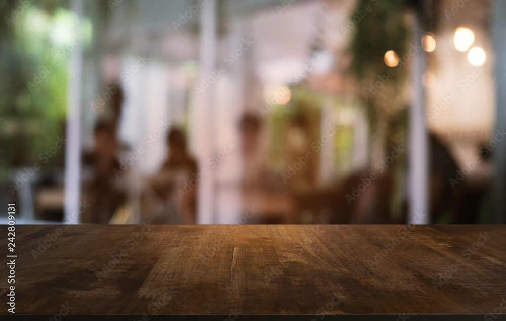 Empty dark wooden table in front of abstract blurred bokeh background of restaurant . can be used for display or montage your products.Mock up for space.