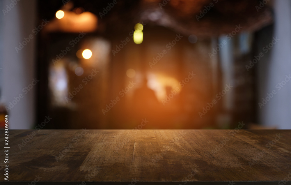 Empty dark wooden table in front of abstract blurred bokeh background of restaurant . can be used for display or montage your products.Mock up for space. Empty dark wooden table in front of abstract blurred bokeh background of restaurant . can be used for display or montage your products.Mock up for space.
