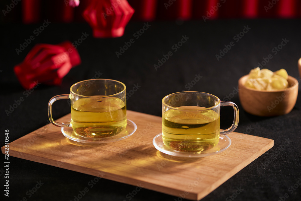 Lunar new year food and drink still life on black background. Translation of text paper in image: Prosperity Lunar new year food and drink still life on black background. Translation of text paper in image: Prosperity