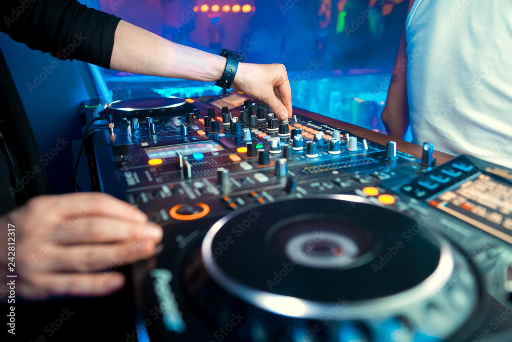 Naklejka premium DJ console cd mp4 deejay mixing desk Ibiza house music party in nightclub with colored disco lights.