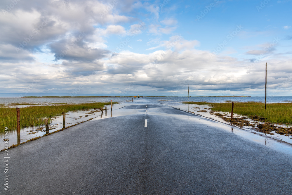 Flooded Road between Beal and the Holy Island of Lindisfarne in Northumberland, England, UK