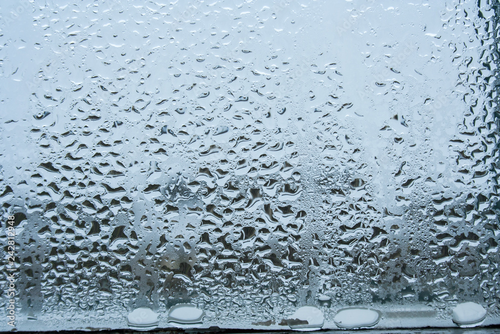 steamy glass. window covered with drops of water vapor steamy glass. window covered with drops of water vapor