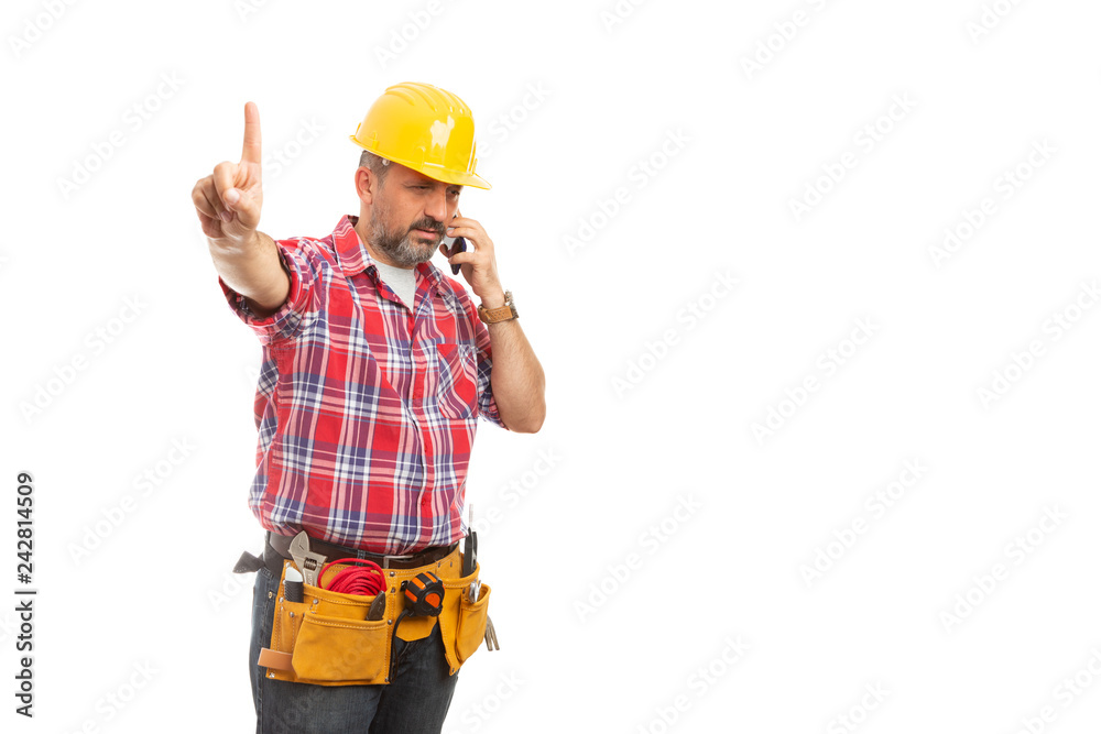 Constructor talking on phone with index finger raised .