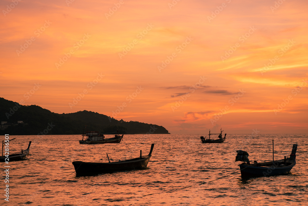 Background sky sunset,Silhouette Thai boat love travel to the beach adventure,Bright in Phuket Thailand.