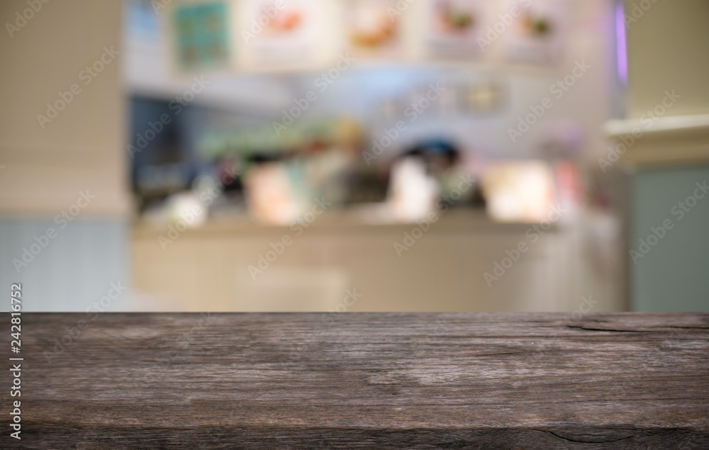 Empty dark wooden table in front of abstract blurred bokeh background of restaurant . can be used for display or montage your products.Mock up for space. Empty dark wooden table in front of abstract blurred bokeh background of restaurant . can be used for display or montage your products.Mock up for space.