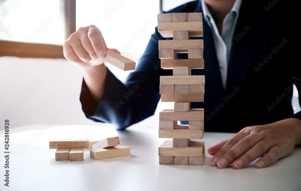 Planning risk and strategy in businessman gambling placing wooden block.Business concept for growth success process