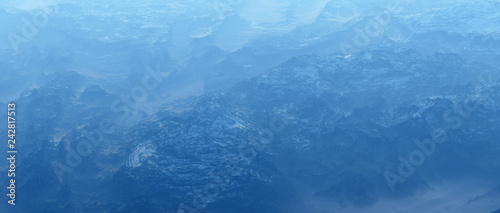 Rough bare mountains with snow in mist. High angle view.