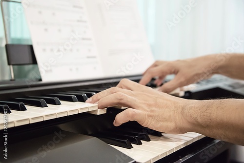 Man hand play electone keyboard - people with music concept photo