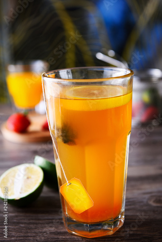 Selection of black tea with lemon in a transparent glass