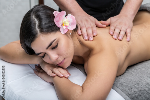 Sensual woman enjoying massage from master