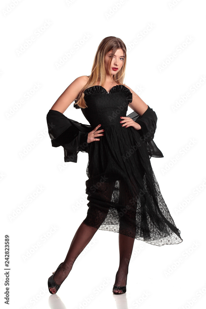 Young blonde lady in black dress posing on white background.Isolated.Posing. Young blonde lady in black dress posing on white background.Isolated.Posing.