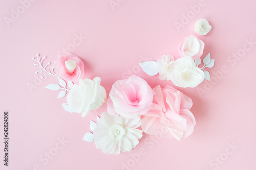 white and pink paper flowers on the pink background © EkaterinaVladimirova