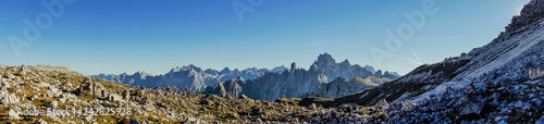 Panorama, widescreen mountain atmospheric view of the Alps with clouds and the horizon line