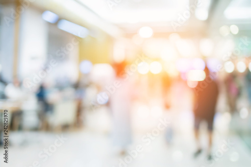 abstract blur defocus background of mall department store with walkway and people shopping