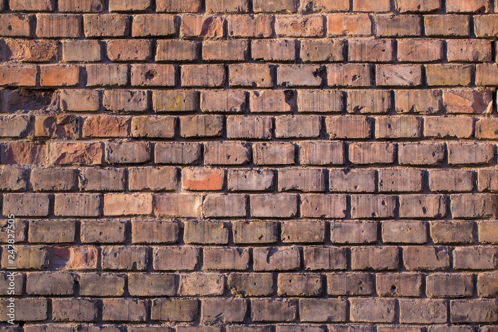 Wall made from red and sometimes colorful bricks of regular shapes and random distribution slotting together precisely. Close up architecture photography. Creative wallpaper photography. Wall made from red and sometimes colorful bricks of regular shapes and random distribution slotting together precisely. Close up architecture photography. Creative wallpaper photography.