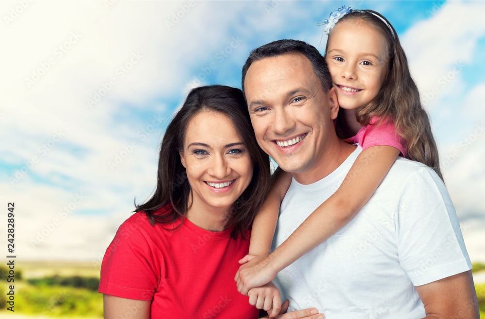 Happy smiling family with daughter on autumn trees background Happy smiling family with daughter on autumn trees background
