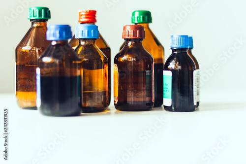 Medicine bottles on white background with copy scape for text, retro concept closeup.