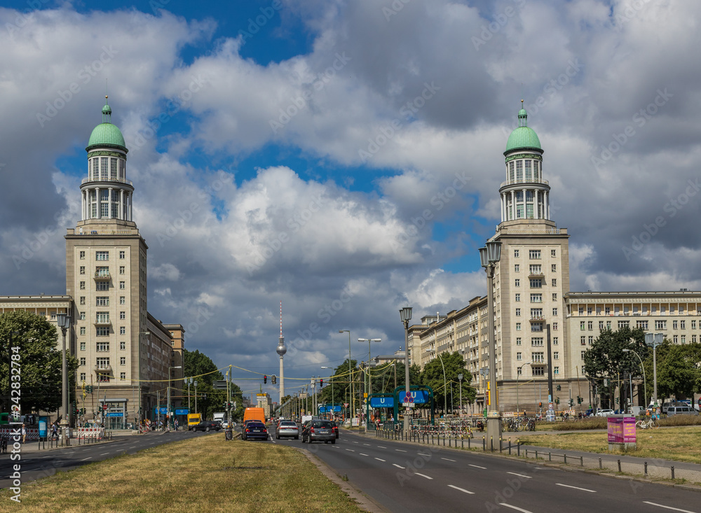 Obraz premium Berlin, Germany - main avenue during of the GDR (East Germany), Karl Marx Allee presents many beautiful buildings. Here in particular an example of its socialist architecture