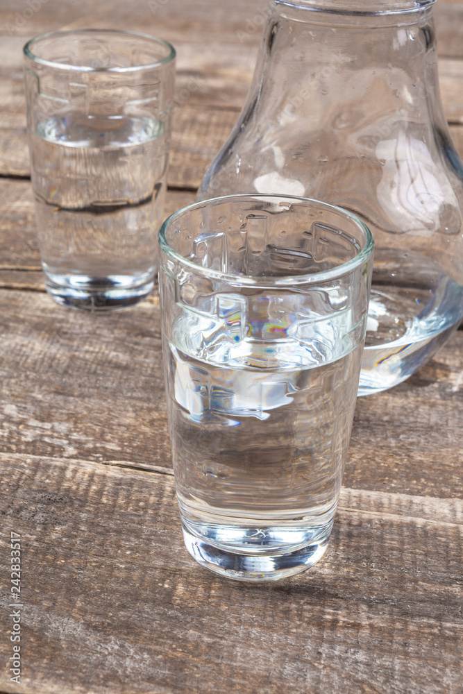 Glass of water on a wooden table Glass of water on a wooden table