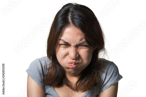 Portrait of angry cute asian woman looking at camera with grey clothes on a white background, With clipping path, Emotion concept.