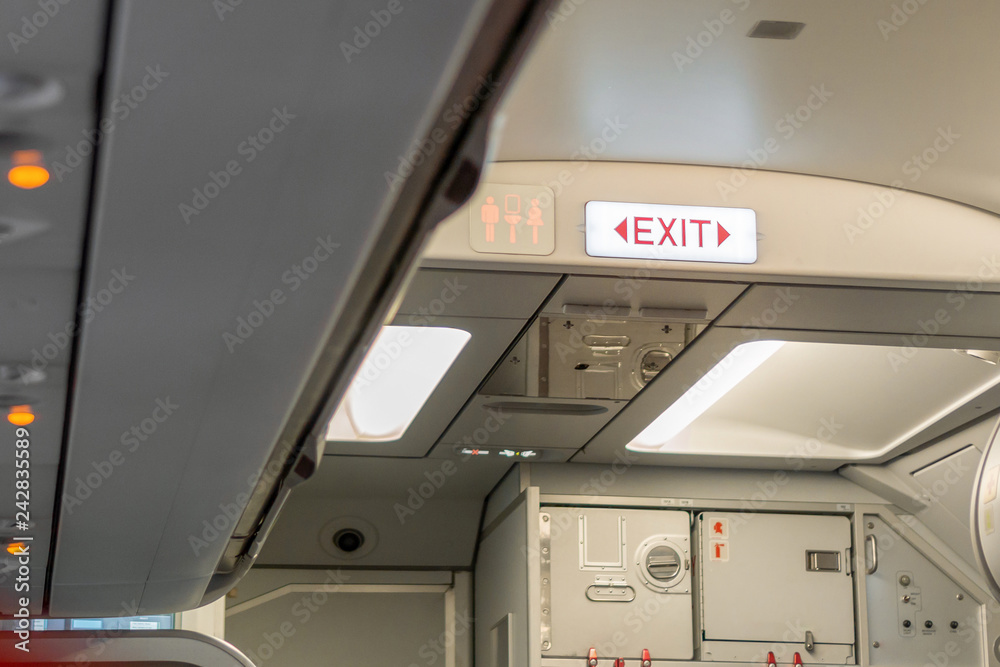 Fire exit sign on airplane, Selective focus. Fire exit sign on airplane, Selective focus.