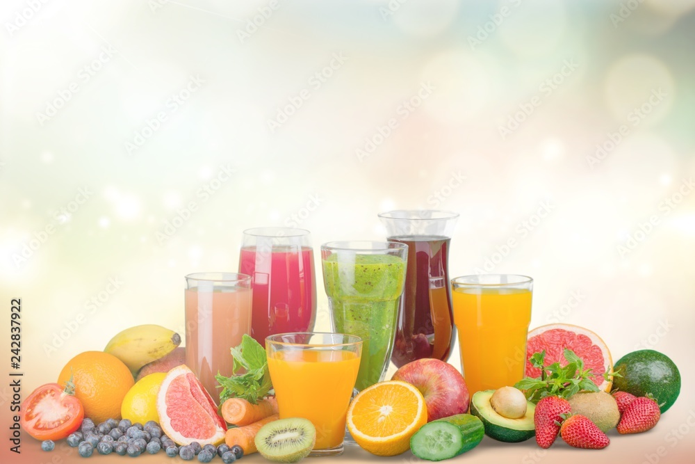 Tasty fruits and juice with vitamins on background Tasty fruits and juice with vitamins on background