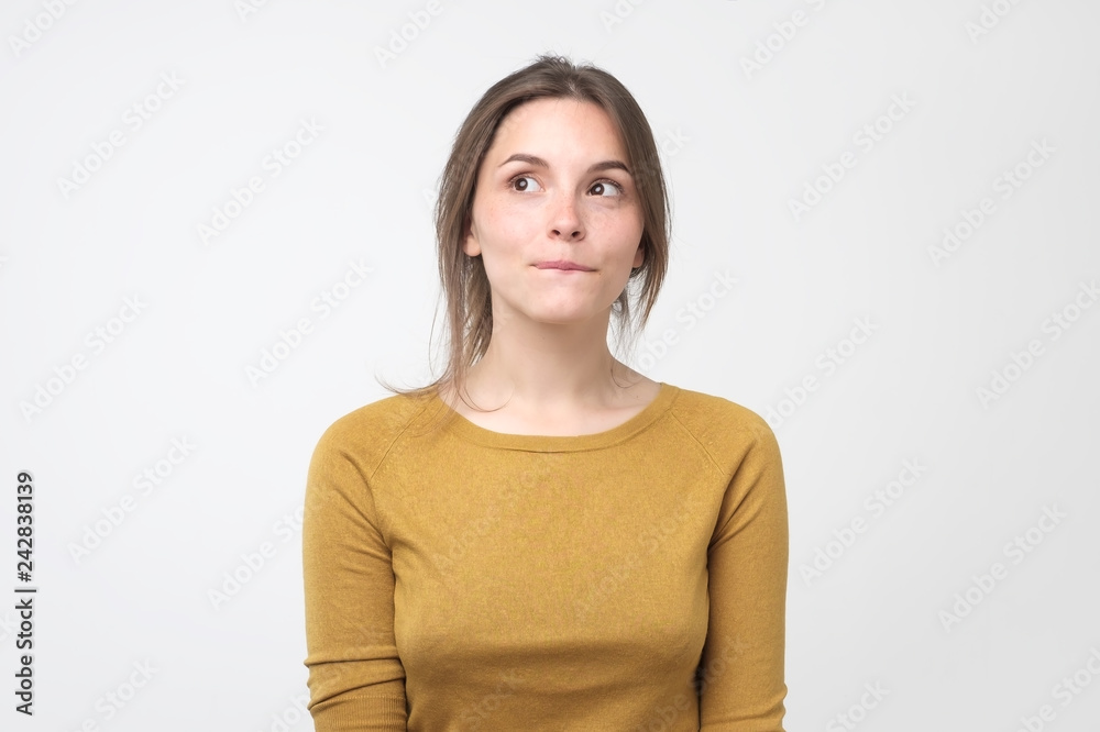 Young tricky woman having something in mind with sly facial expression Young tricky woman having something in mind with sly facial expression
