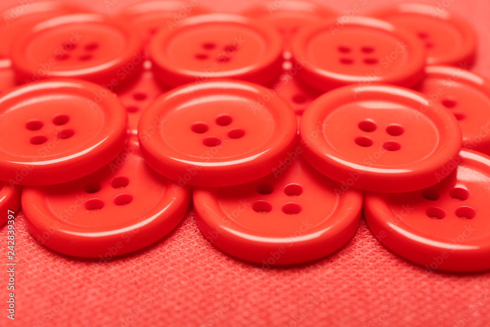 Many coral buttons on fabric, closeup Many coral buttons on fabric, closeup