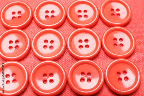 Many coral buttons on fabric