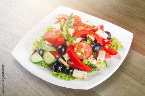Greek salad with fresh vegetables on white background
