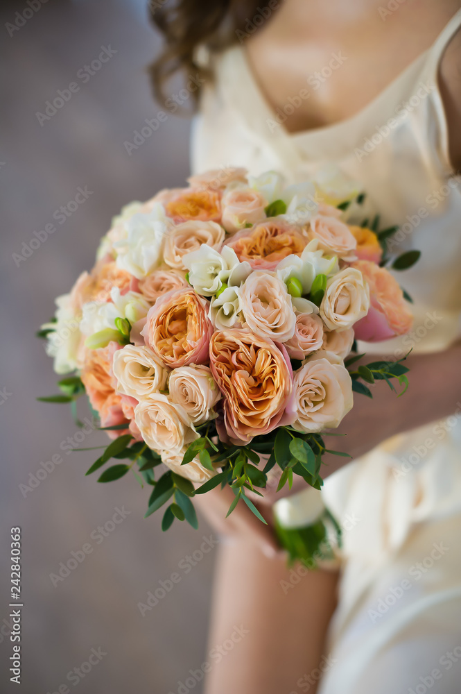 wedding bouquet in the hands of the bride, white and pink peonies