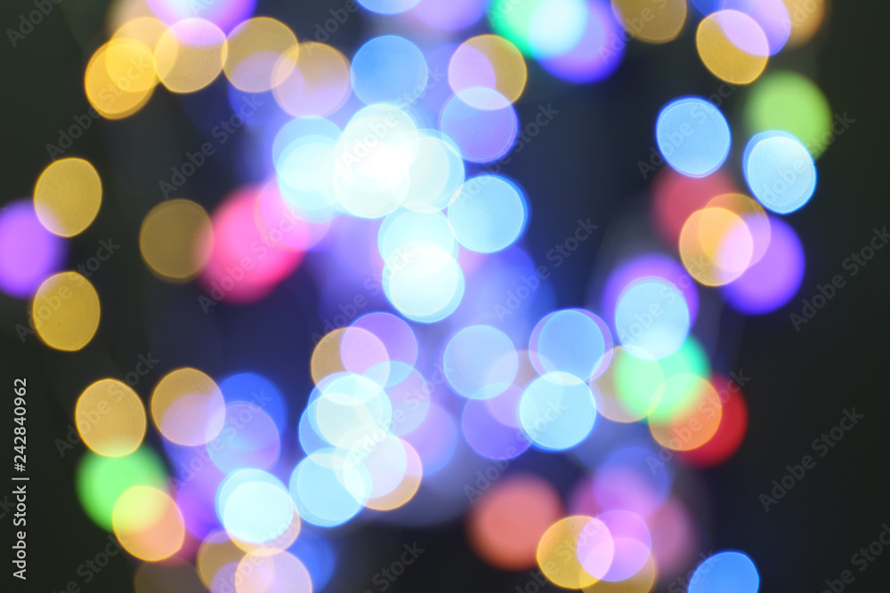 Blurred view of glowing lights on dark background Blurred view of glowing lights on dark background