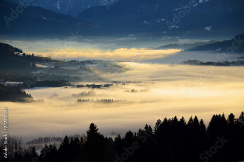 Light falling on fog in valleys of Alpine Foothills in Bavaria seen from Sulzberg, Austria